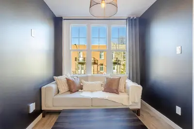 a living room with a couch in front of a window at The Perfect Downtown Hideaway in Montréal