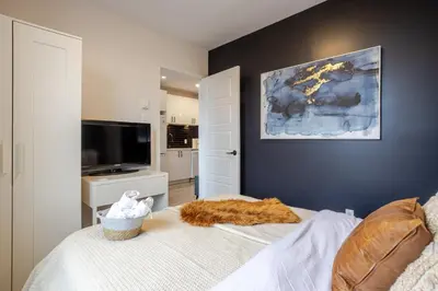 a bedroom with a bed with an orange blanket on it at Spacious 4BR 2BA in the Plateau Montreal in Montréal