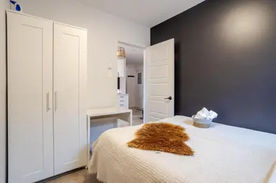 a bedroom with a bed with a brown blanket on it at Spacious 4BR 2BA in the Plateau Montreal in Montréal