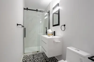 a bathroom with a shower and a sink and a toilet at Spacious 4BR 2BA in the Plateau Montreal in Montréal