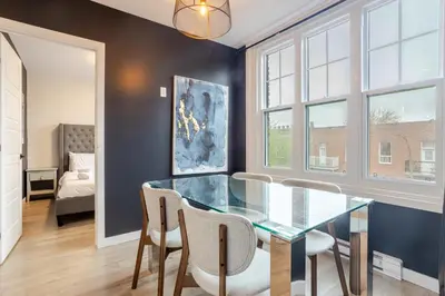 a dining room with a glass table and chairs at Spacious 4BR 2BA in the Plateau Montreal in Montréal