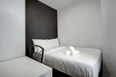 a bedroom with two beds with white sheets at Vibrant 4BR 2BA Retreat in the Plateau in Montréal