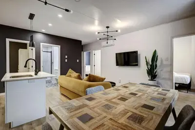 a kitchen and living room with a couch and a table at Vibrant 4BR 2BA Retreat in the Plateau in Montréal