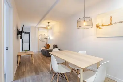 a dining room and living room with a table and chairs at Stunning 3BR on in Plateau Mont-Royal in Montréal