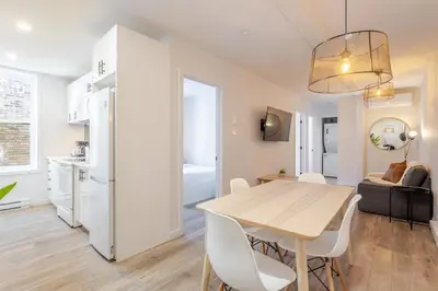 a kitchen and dining room with a table and chairs at Stunning 3BR on in Plateau Mont-Royal in Montréal