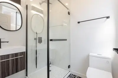 a bathroom with a shower and a toilet and a sink at Stunning 3BR on in Plateau Mont-Royal in Montréal