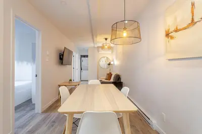 a dining room with a wooden table and chairs at Stunning 3BR on in Plateau Mont-Royal in Montréal