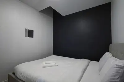 a bedroom with a bed with two towels on it at Elegant 4BR on in the Plateau MTL in Montréal
