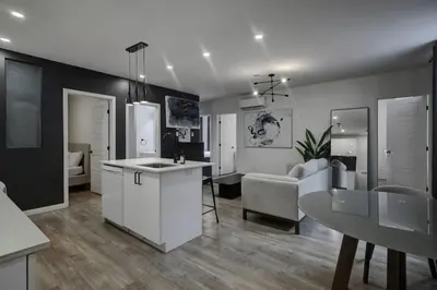 a kitchen and living room with a table and a couch at Elegant 4BR on in the Plateau MTL in Montréal
