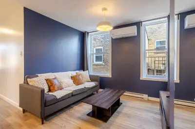 a living room with a couch and a table at Amazing 3-Bedroom on Saint-Urbain in Montréal