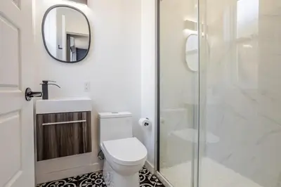a bathroom with a toilet and a glass shower at Amazing 3-Bedroom on Saint-Urbain in Montréal