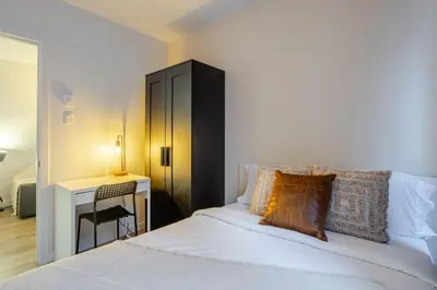 a bedroom with a bed with a desk and a bed sidx sidx sidx at Beautiful 3BR in MTL Mont-Royal in Montréal
