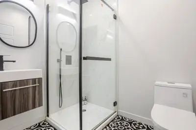 a shower with a glass door in a bathroom at Beautiful 3BR in MTL Mont-Royal in Montréal