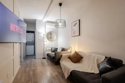 a living room with a couch and a tv at Bright 3BR 2BA in the Plateau in Montréal