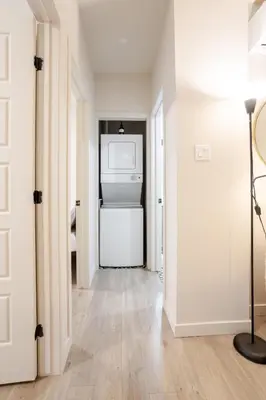a hallway with a washer and dryer in a room at Bright 3BR 2BA in the Plateau in Montréal