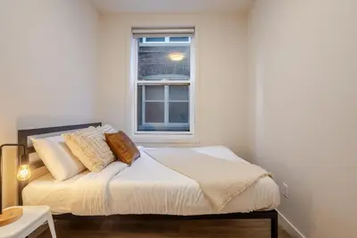 a bedroom with a bed with a window at Bright 3BR 2BA in the Plateau in Montréal