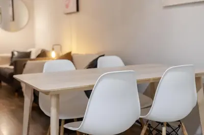 a conference room with a table and white chairs at Bright 3BR 2BA in the Plateau in Montréal