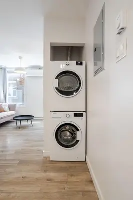 a washing machine and a dryer in a room at Charming 3BR in the Plateau MTL in Montréal
