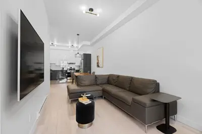 a living room with a couch and a table at New Modern 2bdr Apartment in Little Italy Unit 202 in Montréal