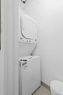 a white room with a toilet and a tv at New Modern 2bdr Apartment in Little Italy Unit 202 in Montréal