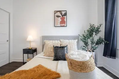 a bedroom with a bed with a rug on it at Large Suite in Downtown Montreal in Montréal