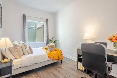 a bedroom with a bed and a desk and a chair at Large Suite in Downtown Montreal in Montréal