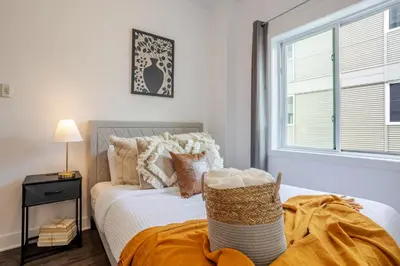 a bedroom with a bed and a window at Large Suite in Downtown Montreal in Montréal