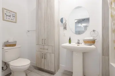 a bathroom with a toilet and a sink and a mirror at Large Suite in Downtown Montreal in Montréal