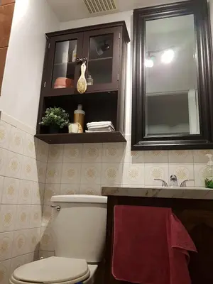 a bathroom with a toilet and a sink and a mirror at Logement 1 pièce Cozy - Parfait pour Courts Séjours in Montréal