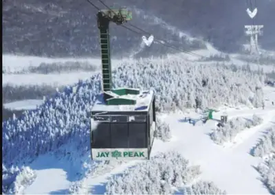 a ski lift with a sign on it in the snow at Détente au coeur de la forêt in Mansonville