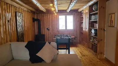 a living room with a couch and a table at Détente au coeur de la forêt in Mansonville