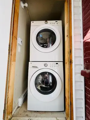 a washer and dryer in a small room at Heart of the City Stay in Montréal