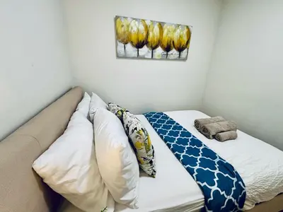a bed in a room with a painting on the wall at Heart of the City Stay in Montréal