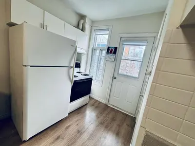 a kitchen with a white refrigerator and a stove at Heart of the City Stay in Montréal