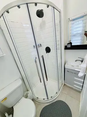 a bathroom with a shower and a toilet at Heart of the City Stay in Montréal