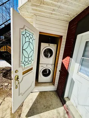 a washer and dryer sitting inside of a door at Heart of the City Stay in Montréal