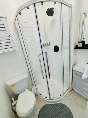 a bathroom with a shower and a toilet at Heart of the City Stay in Montréal