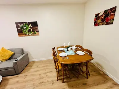 a dining room table with chairs and a couch at Luxe Living Stay in Montréal