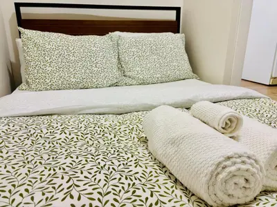 a bed with two pillows and two towels on it at Luxe Living Stay in Montréal