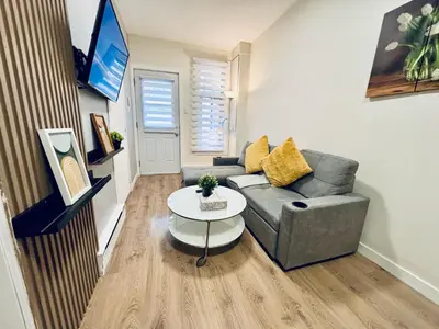 a living room with a couch and a table at Luxe Living Stay in Montréal