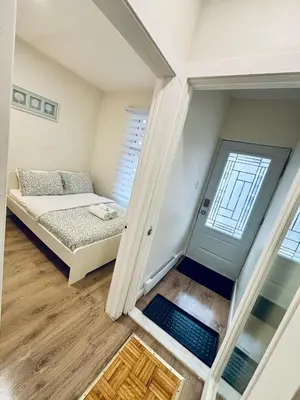 a small room with a bed and a staircase at Luxe Living Stay in Montréal