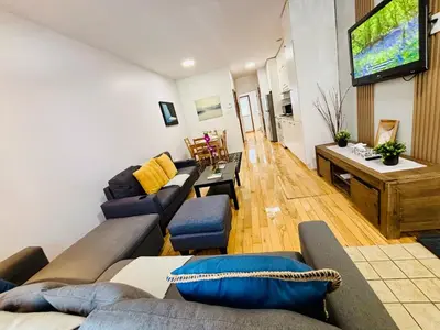 a living room with couches and a television on the wall at Freshly Renovated Stay in Montréal