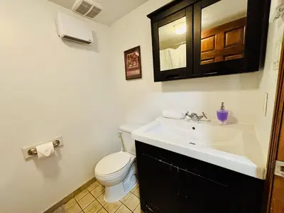 a bathroom with a sink and a toilet at Freshly Renovated Stay in Montréal