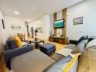 a living room with a couch and a tv at Freshly Renovated Stay in Montréal