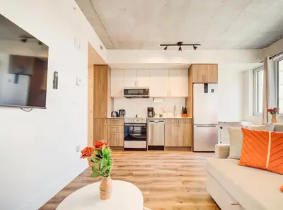 a living room with a white couch and a table at Terracotta 1-BD in Downtown MTL in Montréal