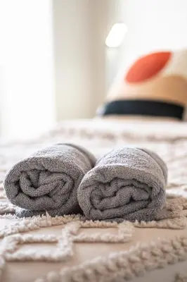 a pair of towels sitting on top of a bed at Terracotta 1-BD in Downtown MTL in Montréal