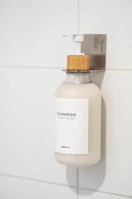 a bottle of shampoo sitting on a wall at Terracotta 1-BD in Downtown MTL in Montréal