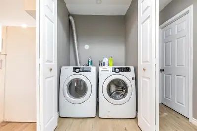 a laundry room with a washer and dryer at Three bedroom apartment Free parking EV charger in Longueuil