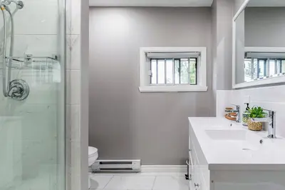a bathroom with a shower and a sink and a toilet at Three bedroom apartment Free parking EV charger in Longueuil