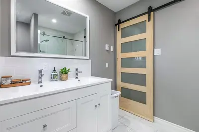 a bathroom with a sink and a mirror at Three bedroom apartment Free parking EV charger in Longueuil